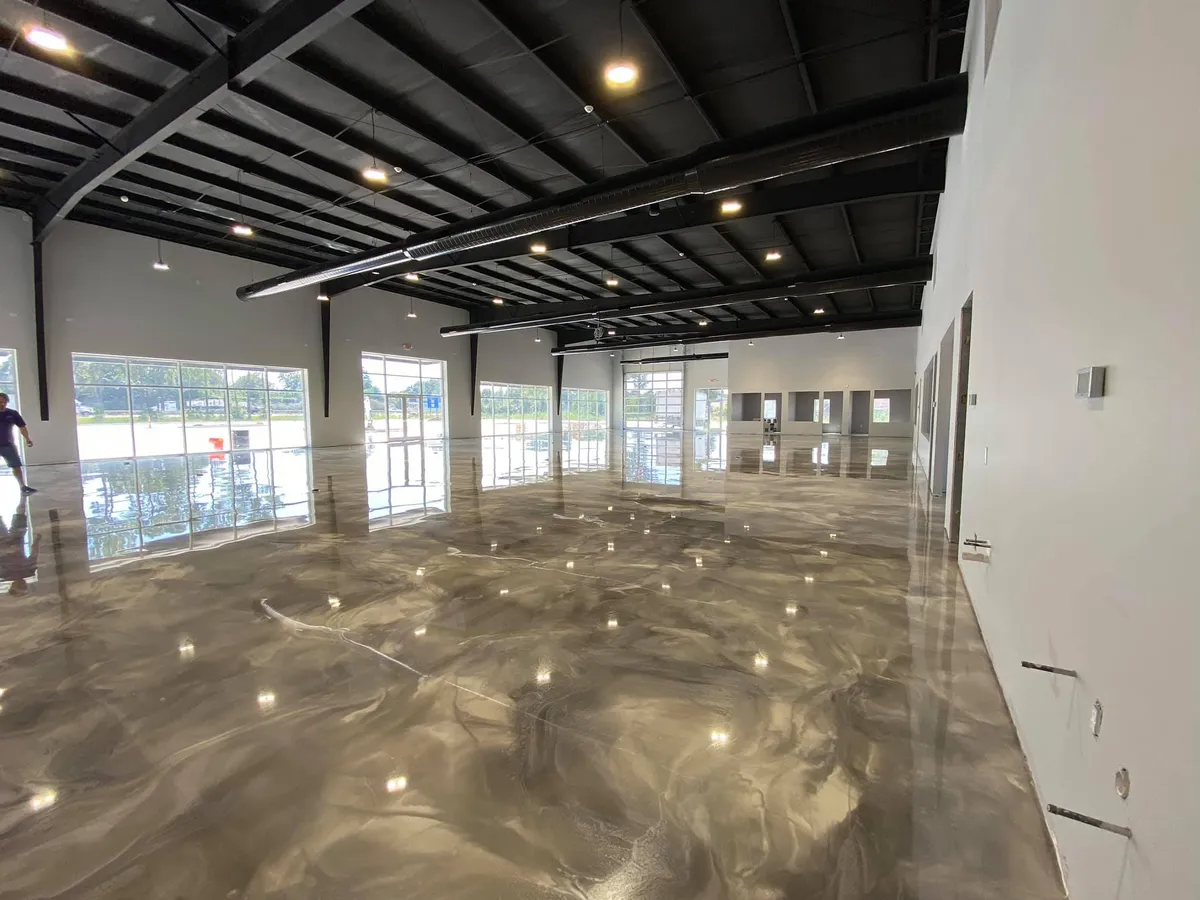 Concrete Masters v2 Metallic epoxy flooring in corporate showroom with silver and charcoal swirl pattern in Atlanta, Georgia