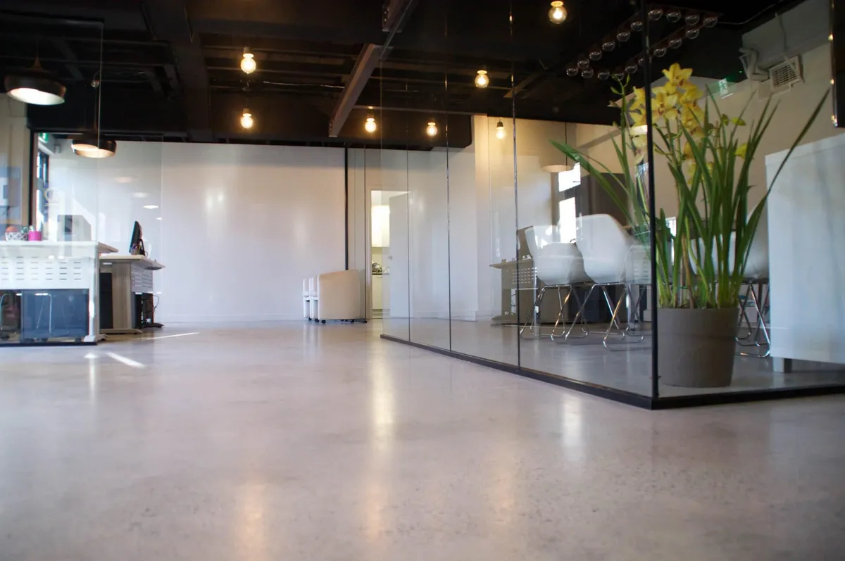 Concrete Masters v2 High-gloss polished concrete office lobby with medium aggregate exposure in Buckhead, Atlanta, Georgia