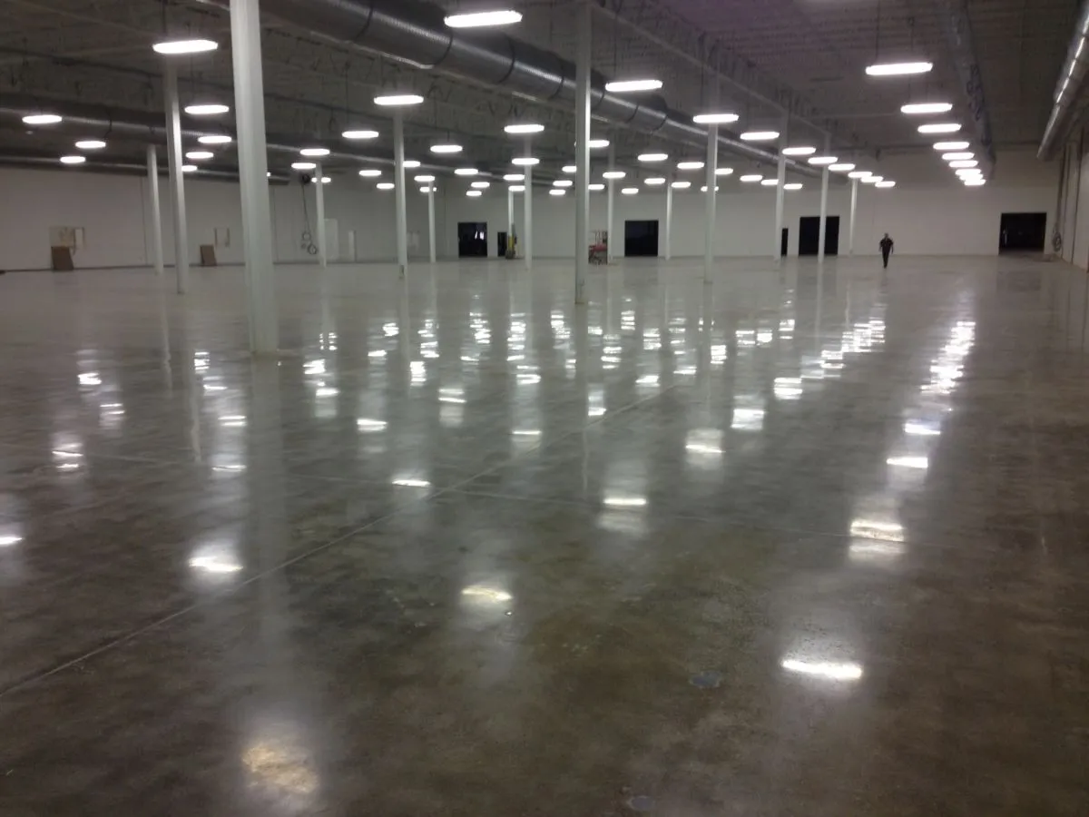 Concrete Masters v2 Polished concrete warehouse floor with high-gloss diamond finish reflecting overhead lighting in Atlanta, Georgia